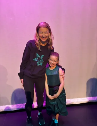 Katy Finlay with a VPS student on stage
