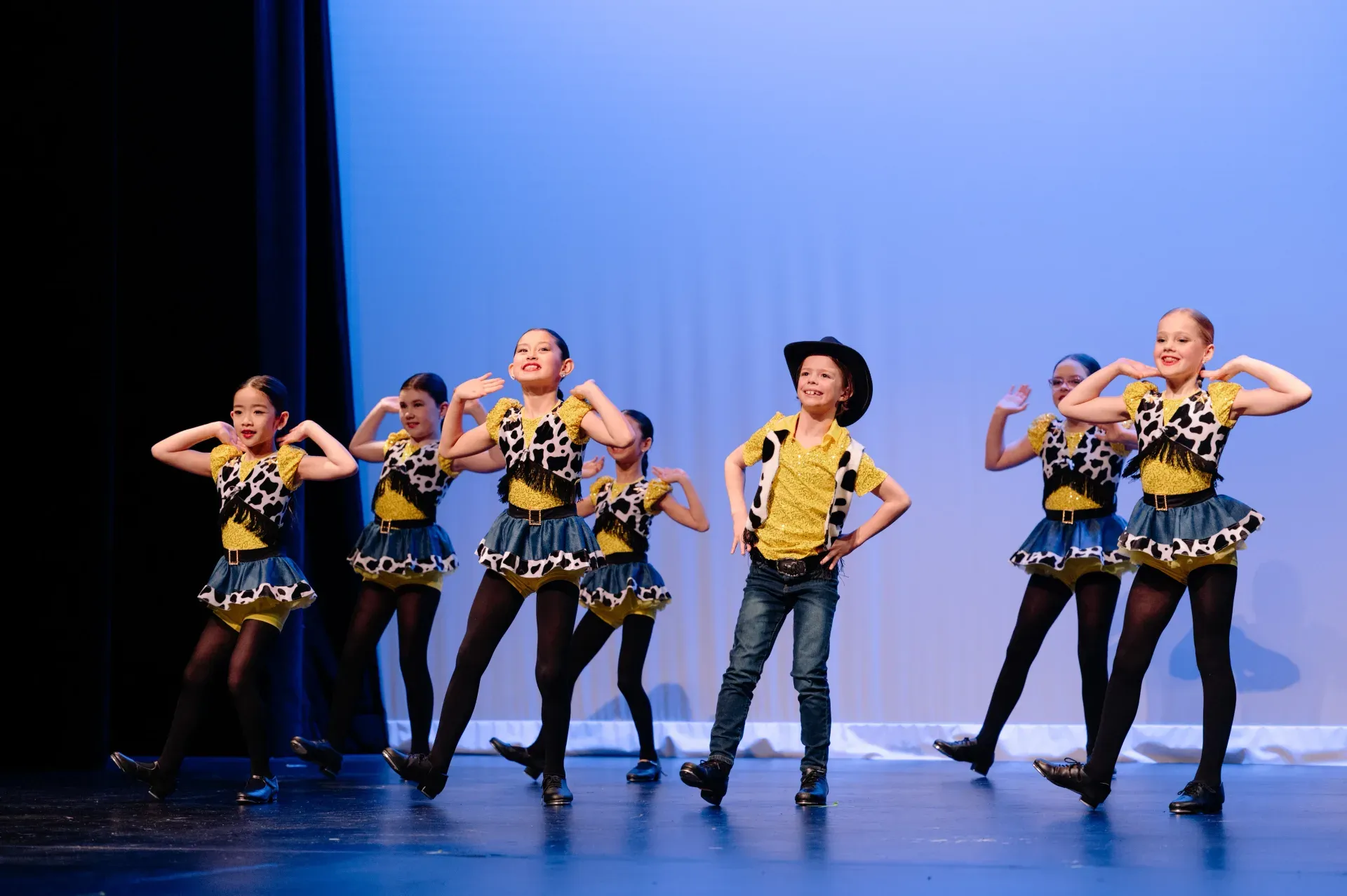 VPS Starjump Academy tap and jazz students performing on stage in yellow and black cowboy costumes