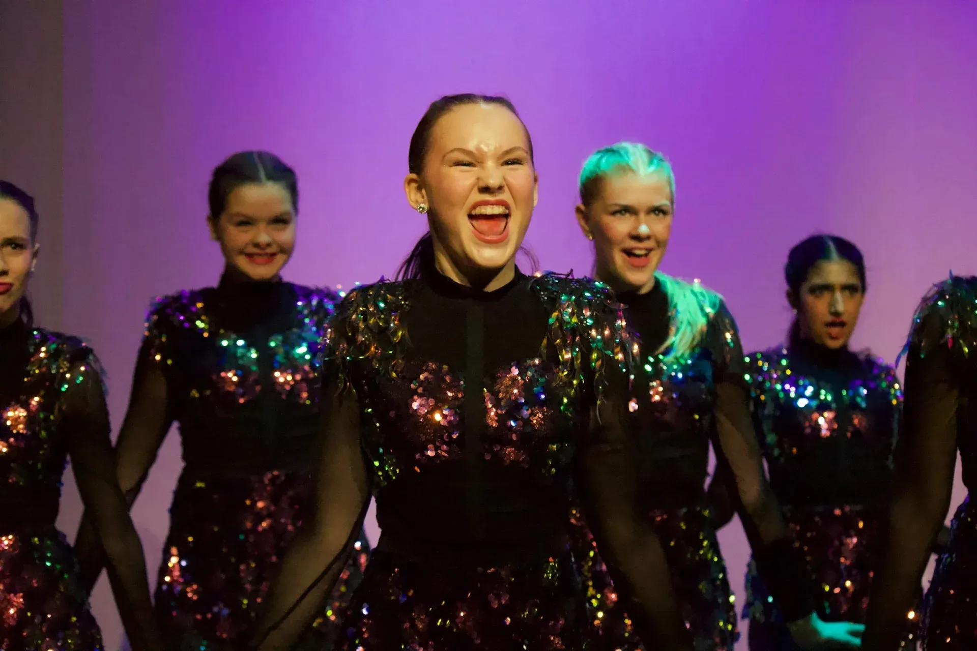 Young dancers in sparkling sequin costumes performing on stage at Vancouver Performing Stars